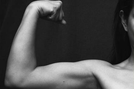 woman's arm flexing biceps