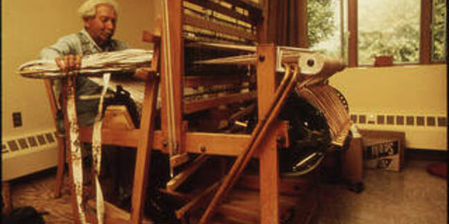Old man sitting at a loom