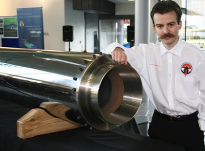 Daniel Jubb poses with his hybrid motor. Pic: Bloodhound SSC