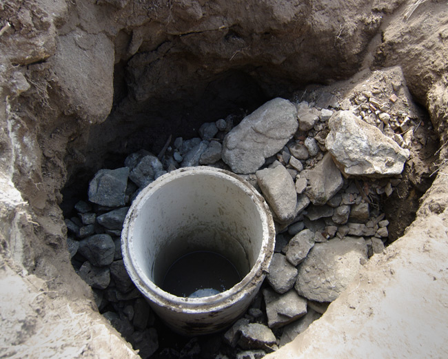 The frist two sections of tube in place and surrounded with stone