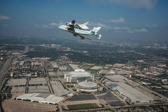 Space shuttle Endeavour over Reliant Stadium and Astrodome