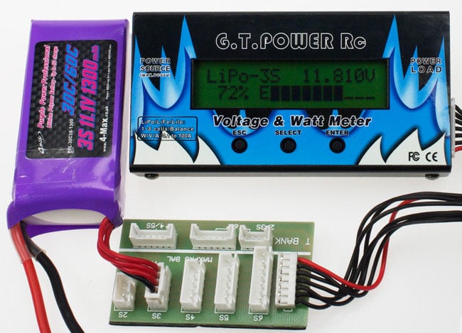 The LiPo connected to the meter, which is showing voltage and charge capacity