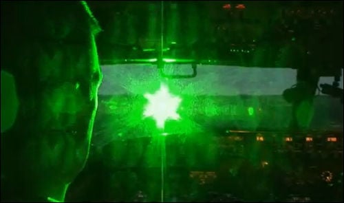 Simulated photo of a green laser striking an aircraft cockpit