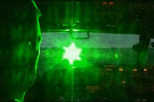 Simulated photo of a green laser striking an aircraft cockpit