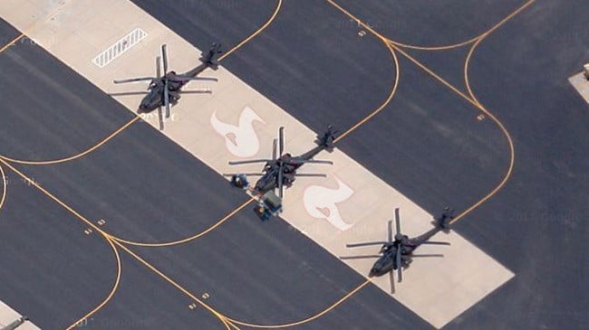 A closer aerial view with three black helicopters