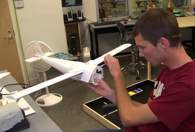 A student works on the skinning of the USI plane