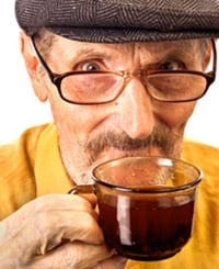 Old man drinking cup of tea
