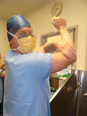 Richard Youd scrubs before his surgical training. Photo Copyright Pip