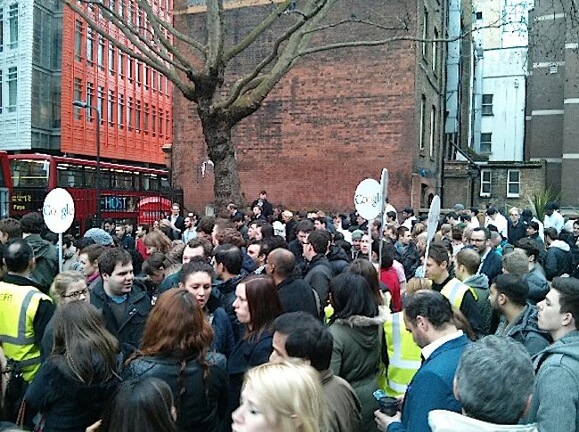 People standing outside St Giles in central London with Google signs