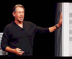 Larry Ellison lovingly pats his first Oracle mainframe