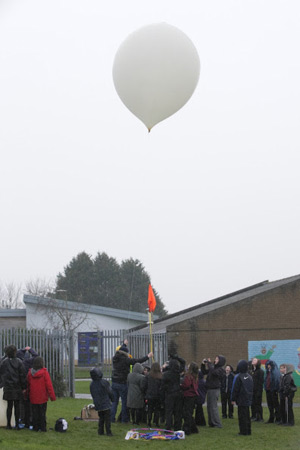 One mission balloon ready for lift-off, as the schoolkids gather round