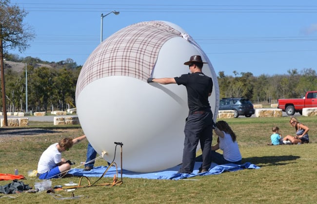 The massive balloon held under a couple of sheets