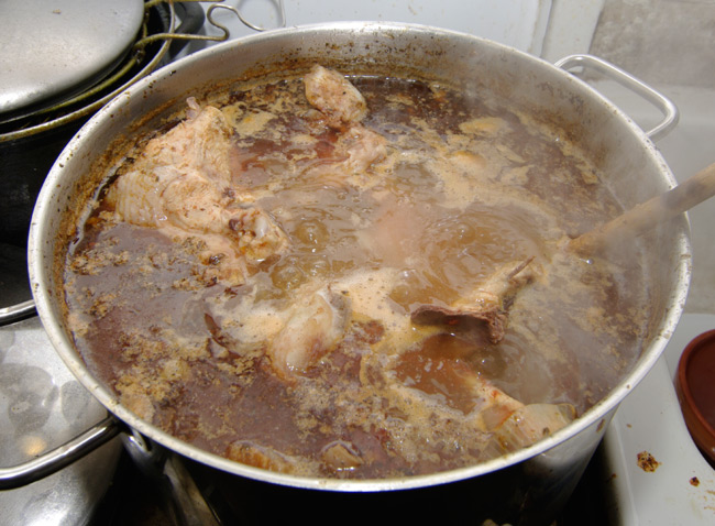 Big pan of boiling chickpea and bone stew