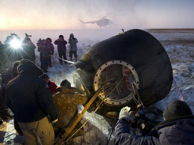 Russian support personnel work to help get crew members out of the Soyuz TMA-02M spacecraft shortly after the capsule landed with Expedition 29 Commander Mike Fossum and flight engineers Sergei Volkov and Satoshi Furukawa in a remote area outside of the town of Arkalyk, Kazakhstan, at 9:26 p.m. EST on Monday, Nov. 21, 2011. Pic: NASA/Bill Ingalls