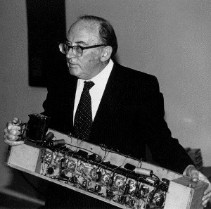 Sir Maurice Wilkes holds computer component