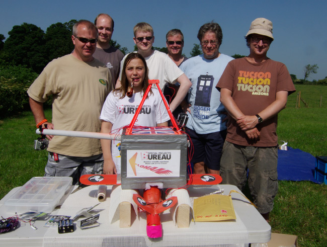 The test flight team pose with the payload before the flight