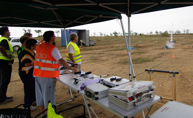 Launch of a rocket seen from behind the launch control tent