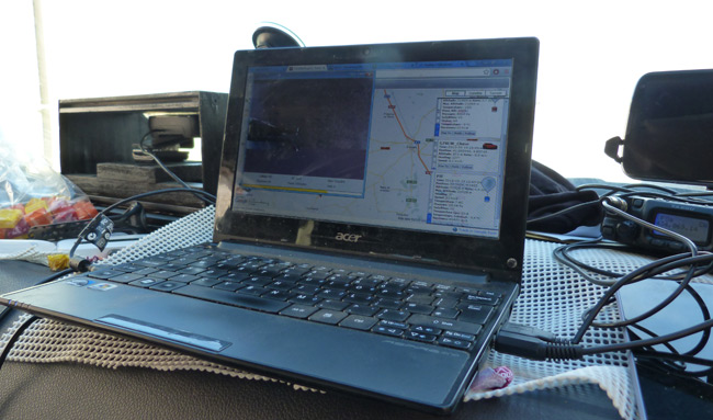 The tracking laptop on the dashboard of the pursuit van