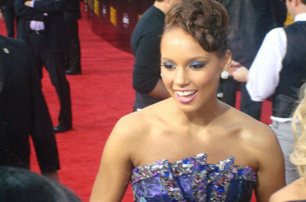 Alicia Keys at a red carpet event in a blue, jewelled gown with upswept hairdo. Photo by Keith Hinkle, licensed under creative commons attribution