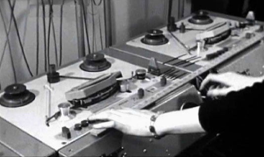 Delia Derbyshire plays a tape loop on a Philips EL3503