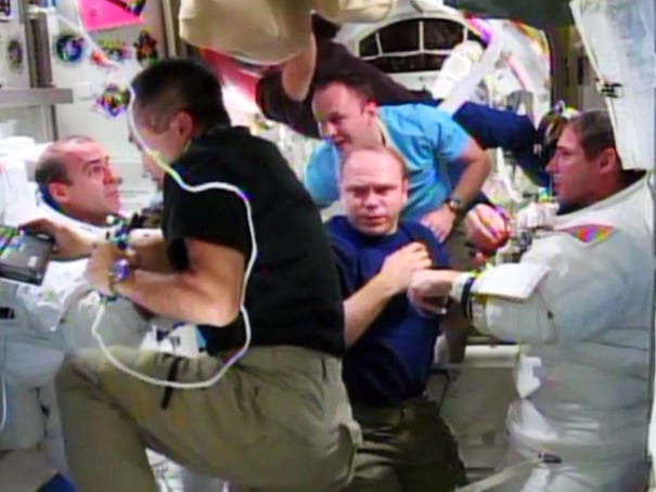 Rick Mastracchio (left) and Mike Hopkins (right) are assisted by the rest of their Expedition 38 crew mates after the completion of their Dec. 24 spacewalk