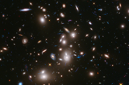 Long-exposure Hubble Space Telescope image of massive galaxy cluster Abell 2744 (foreground) and some of the faintest and youngest galaxies ever detected in space.