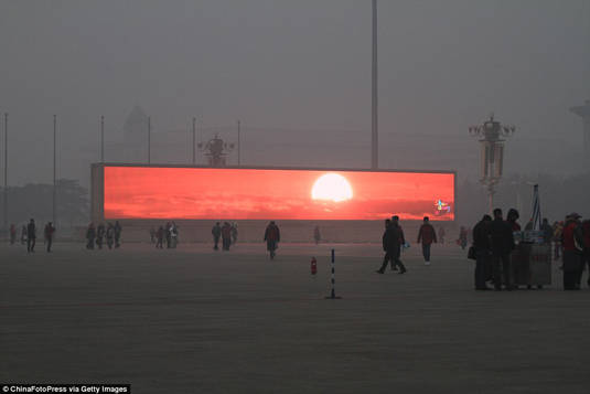 Sunset being televised in Beijing's Tiananmen Square due to heavy pollution