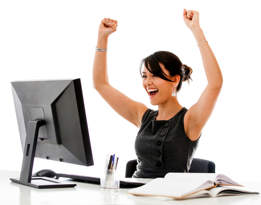 Woman looks immensely happy while staring into blank screen of unplugged monitor