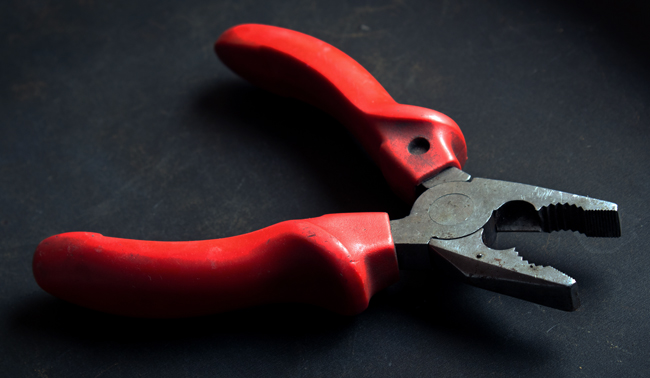 A pair of pliers in the shadows