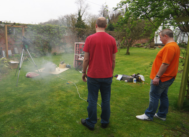 Smoke billows from the REHAB chamber as Paul and Rob look on