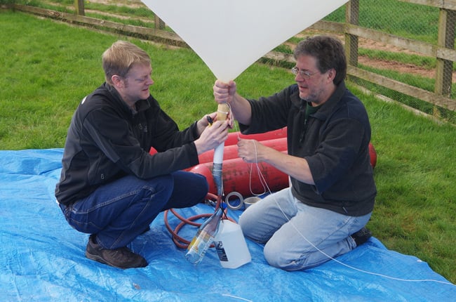 Dave and Anthony tie off the filled balloon