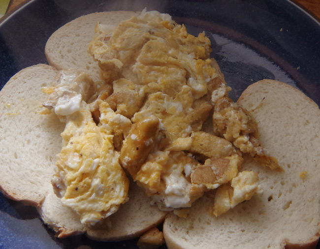 A plate of scrambled eggs and mushrooms