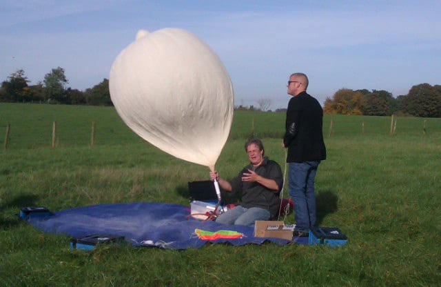 Dave filling the balloon as Heston looks on