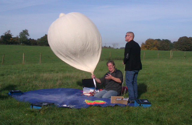 Dave filling the balloon as Heston looks on