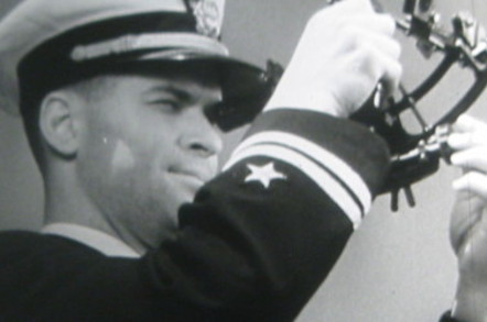 An officer of the U.S. Navy uses a sextant to determine his position.