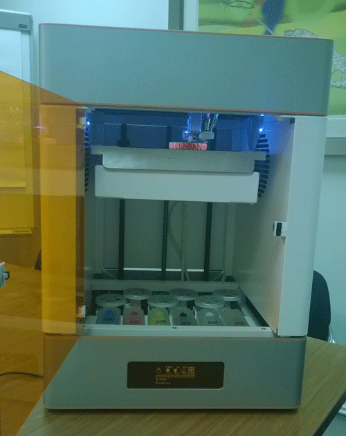 The build platform raised and the filament below