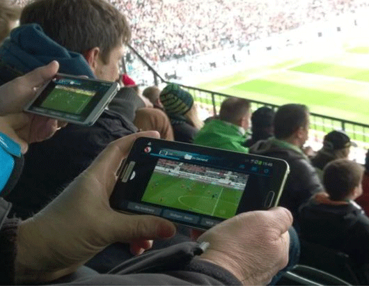 Seond screen is one thing at home, but watching one game while visiting another is obessive