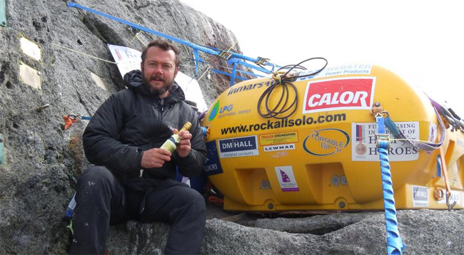 Nick Hanock on Rockall with his survival podule and a small bottle of champagne