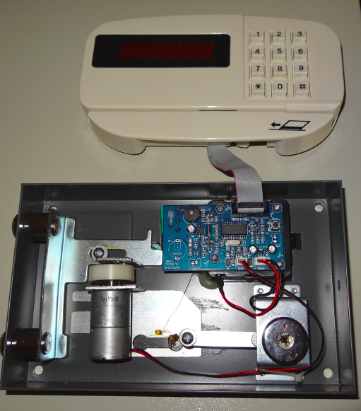 The input panel, in front of the safe, to enter the PIN code or swipe a card through the credit card reader The opening mechanism, behind the door