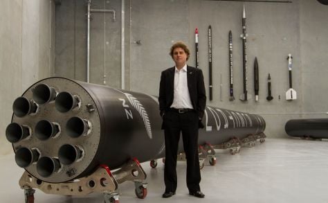 Rocket Lab's Peter Beck with a model of the launcher