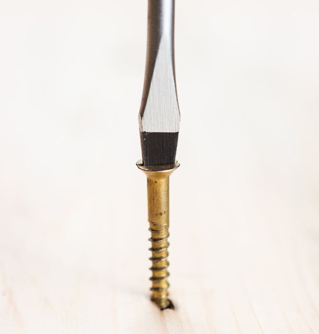 A screwdriver driving a screw