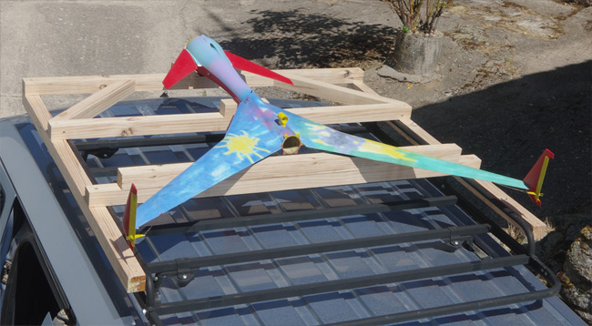 The Vulture 2 on a wooden frame atop the van's roof rack