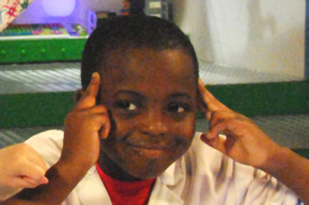Smiling child with head in hands