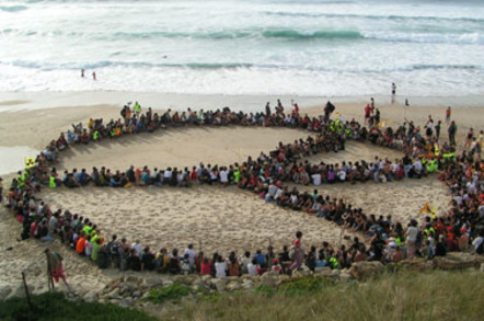 Hippies stage sitdown on beach (in shape of peace sign)