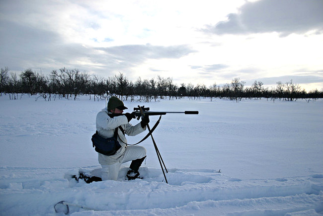Sportsman with moderated rifle in snow. Pic: Juha Perovuo