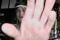 Woman puts hand in camera lens. Pic: Steve Purkiss