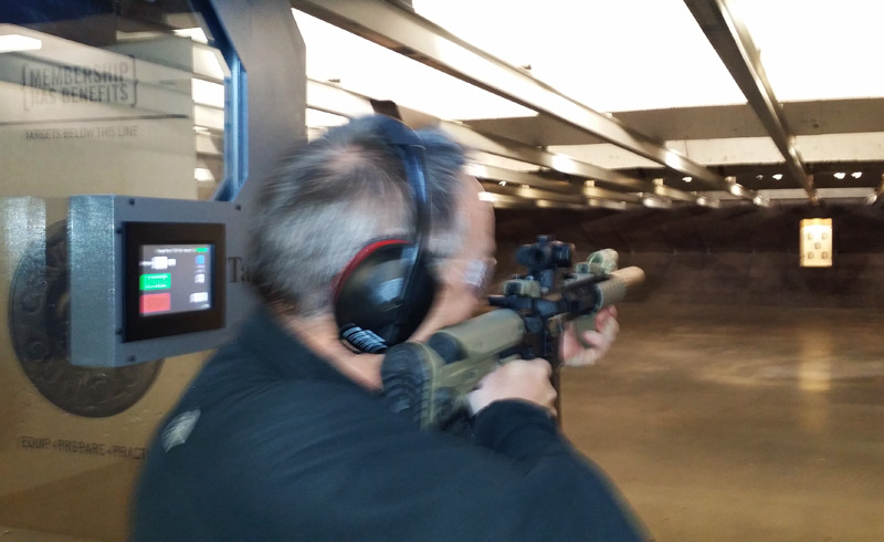 Lester firing an AR-15 at the gun range