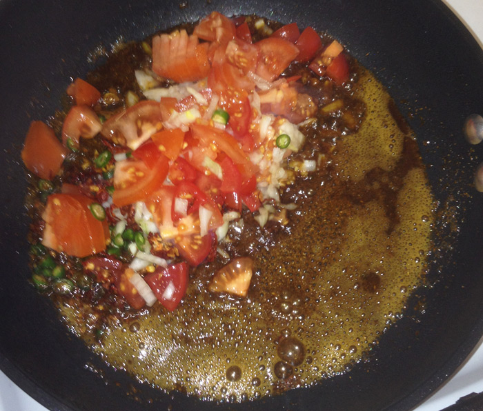 Frying the ingredients for the masala omelette