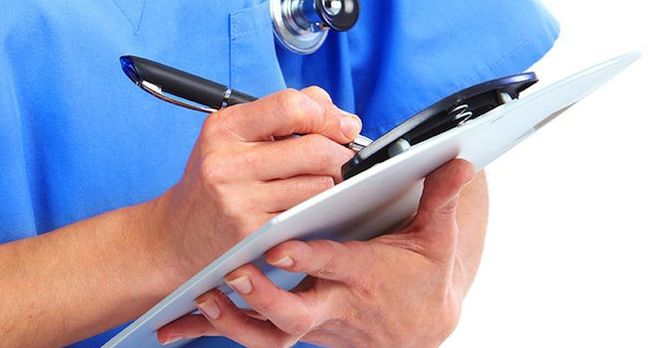 Crop of doctor with pen and clipboard