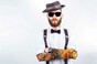 Young hipster man wearing hat, suspenders, bow-tie and fake-looking tattoo-sleeve. Image via shutterstock